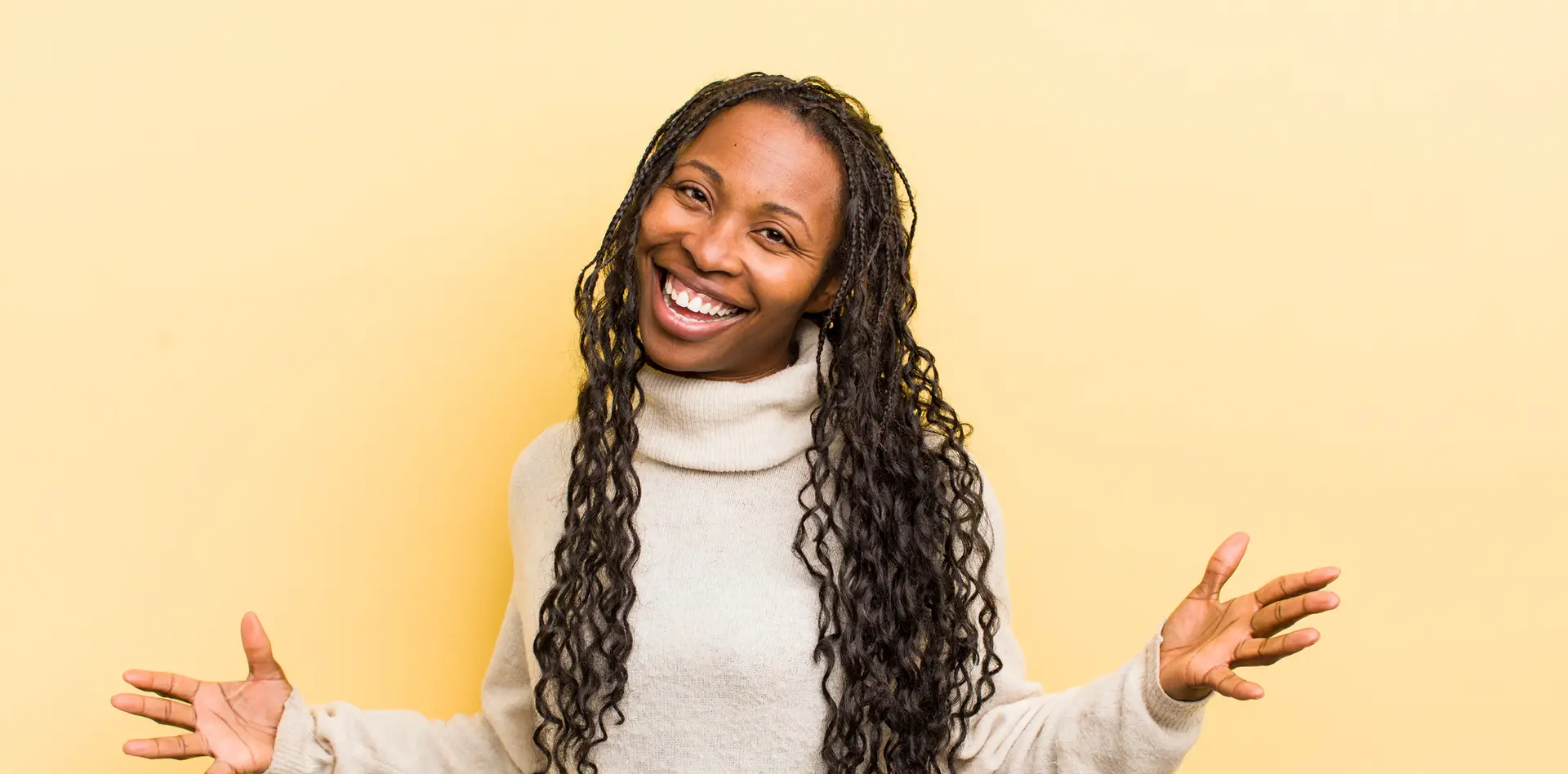 Black woman with long hair smiling and hold hands out and open